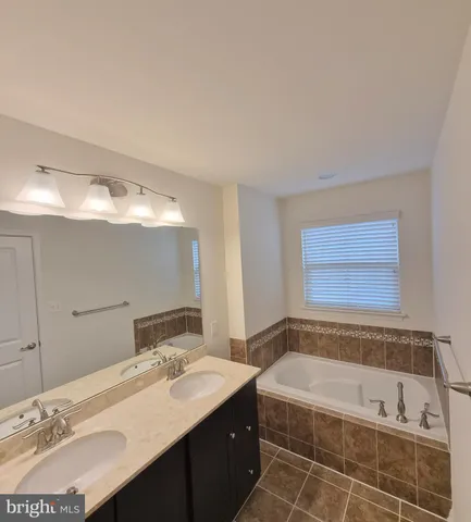 a bathroom with a bathtub and a sink