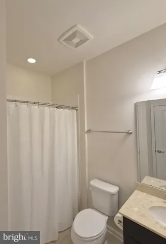 a white toilet sitting next to a bathroom sink