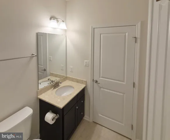 a bathroom with a sink vanity and a mirror