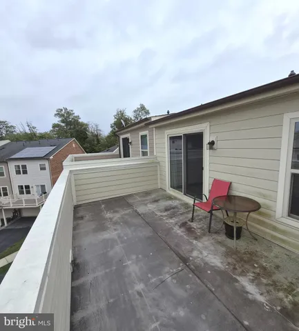 a view of a chair and tables in the patio