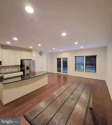 a view of kitchen with stainless steel appliances refrigerator oven and cabinets