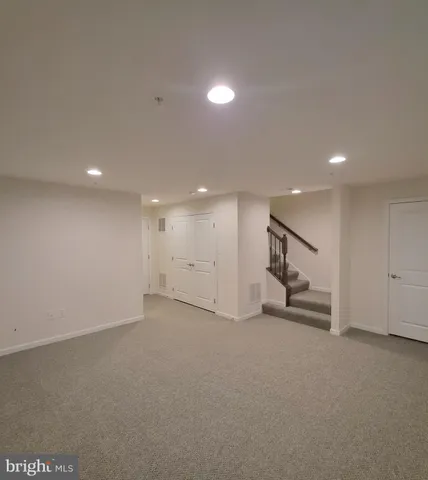 an empty room with a projector and white walls