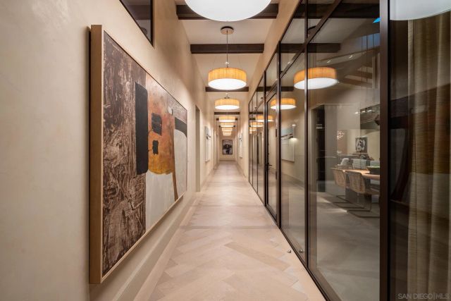 a view of a hallway with wooden floor and entryway