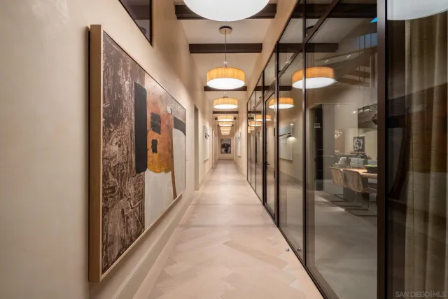 a view of a hallway with wooden floor and entryway