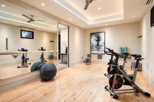 a room with gym equipment and a view of living room