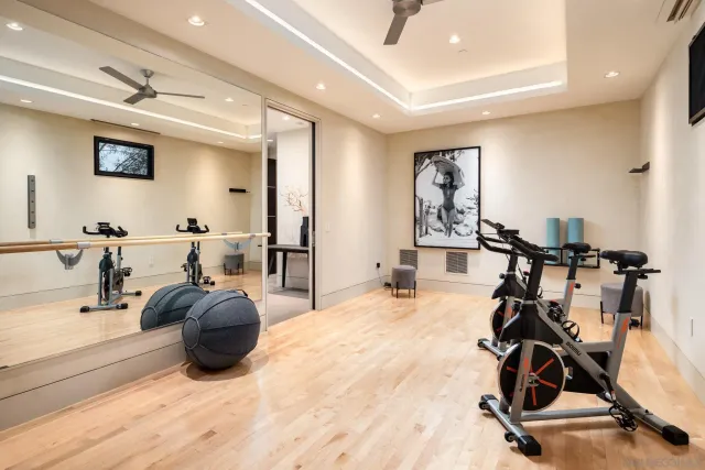 a room with gym equipment and a view of living room