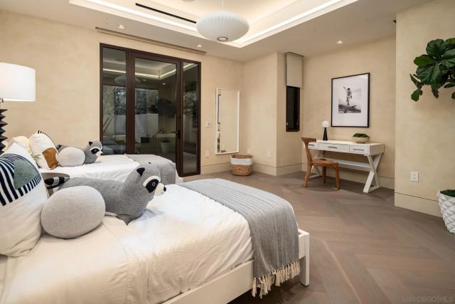 a bedroom with two beds and a table