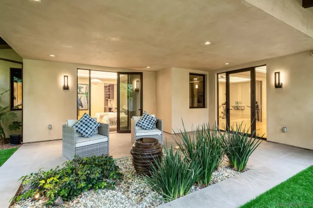 a living room with furniture and a floor to ceiling window