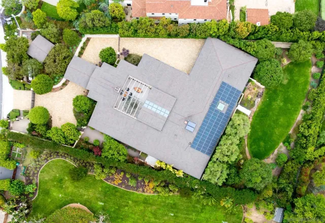 an aerial view of a house with a yard