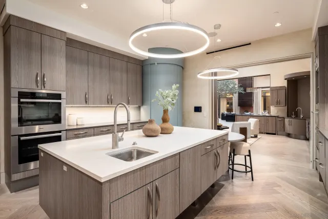 a kitchen with a sink a stove and chairs