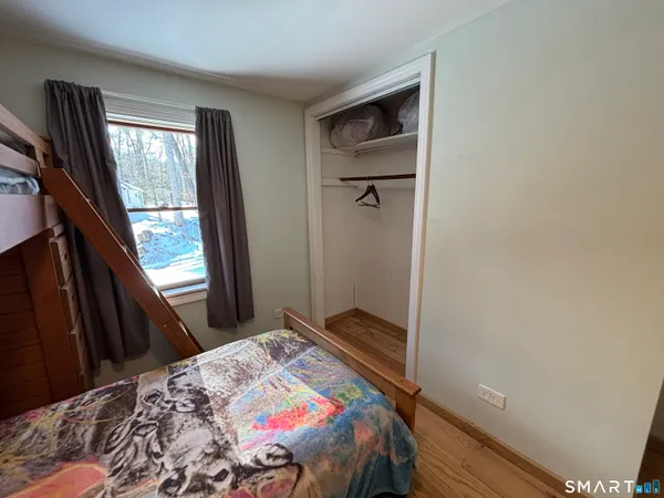 a bedroom with a bed and window