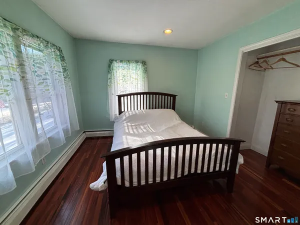 a bedroom with a bed and a large window