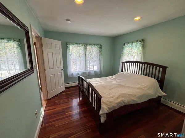a wooden house with trees in front of it