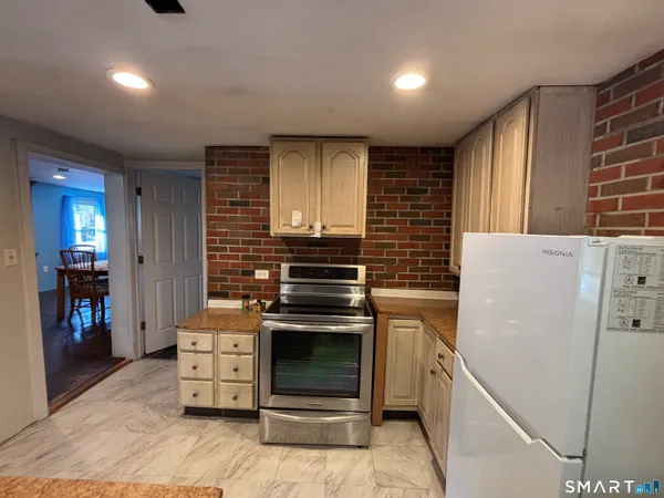 a kitchen with a stove and a refrigerator