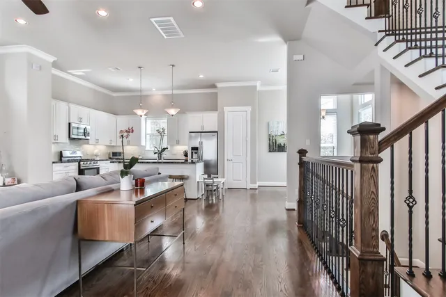 a living room with lots of furniture and kitchen view