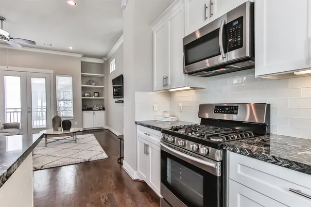 a kitchen with stainless steel appliances a stove a microwave and cabinets