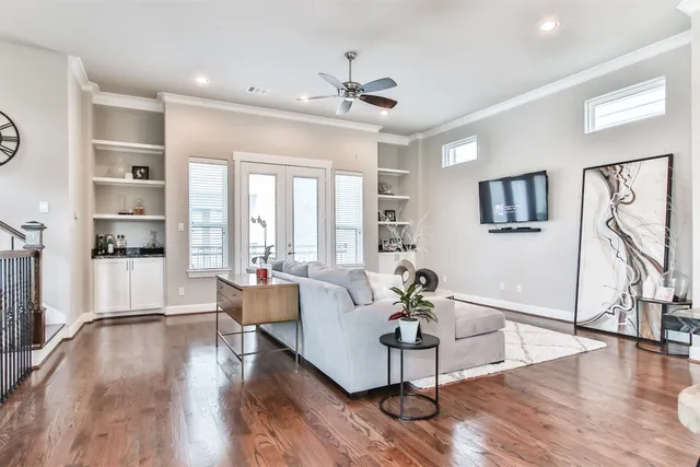 a living room with furniture and a wooden floor
