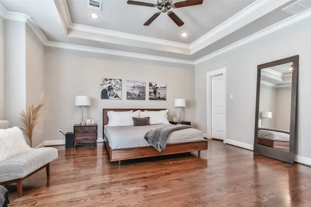 a bedroom with a bed and flat screen tv