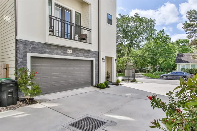 a front view of a house with a yard and a garage