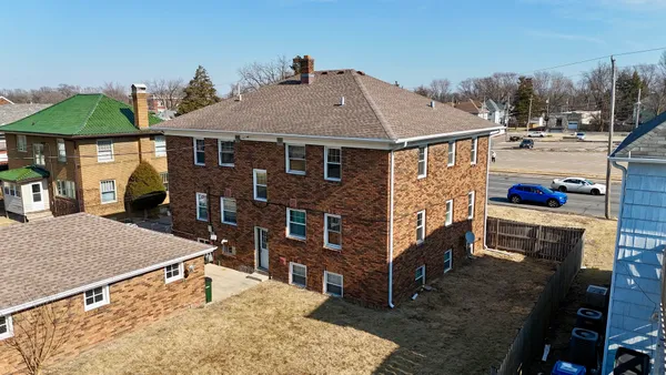a aerial view of a house with a yard