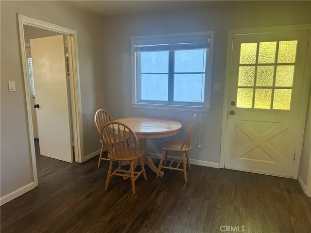 a dining room with furniture and wooden floor