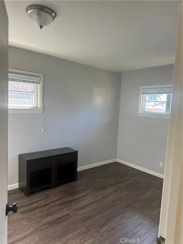 wooden floor in an empty room with a fireplace