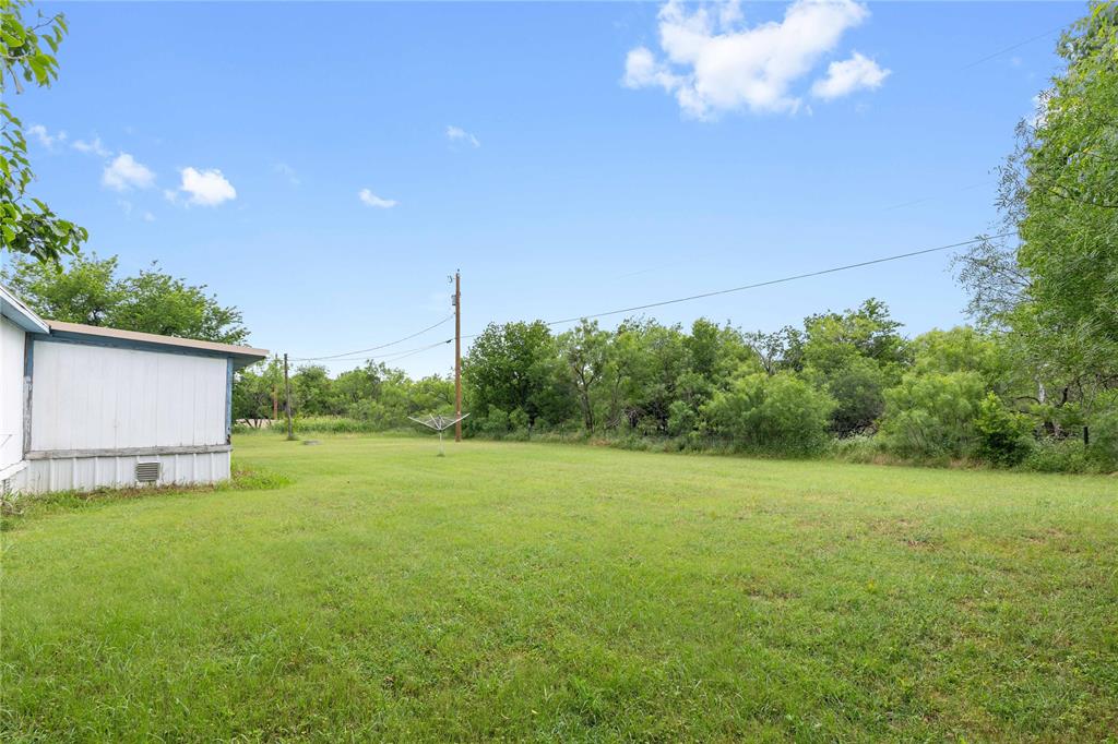 210 7th Street Blanket, TX 76432 - Photo 28 of 33 a view of a big yard with an outdoor space and seating area