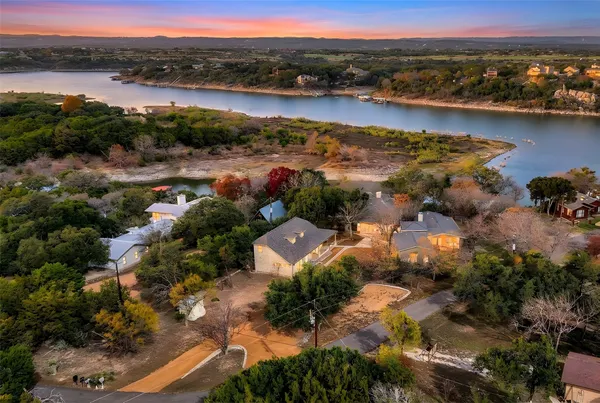 an aerial view of residential building with outdoor space and lake view