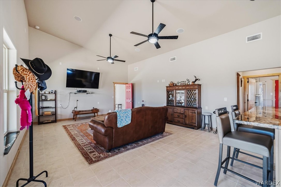 10374 East Happy Trails Road Kingman, AZ 86401 - Photo 9 of 68 a living room with furniture a flat screen tv and a window