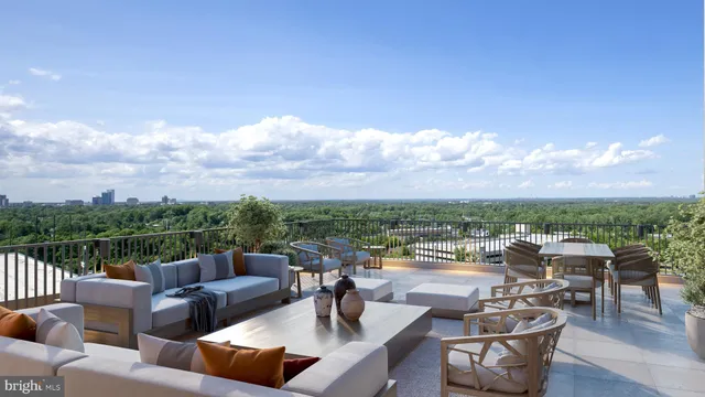 a view of a terrace with couches and lounge chairs