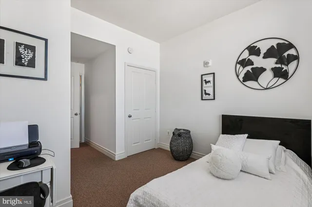 a bedroom with a bed and a television