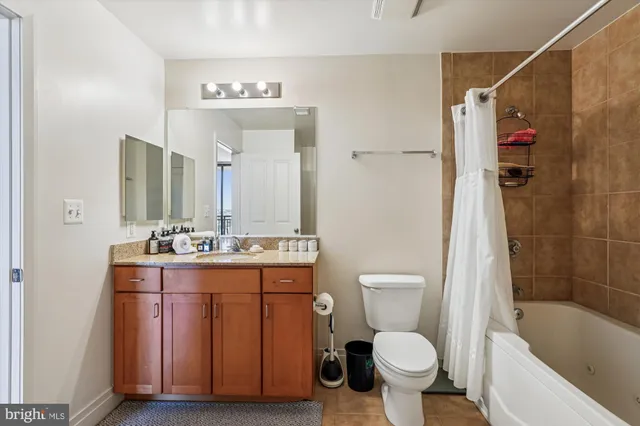 a bathroom with a sink toilet vanity and shower