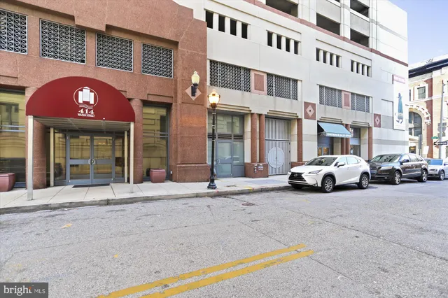 a view of a building with car parked