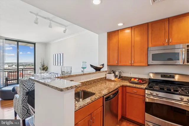a kitchen with a stove a sink and a microwave