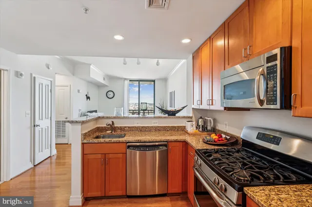 a kitchen with granite countertop a stove and a sink