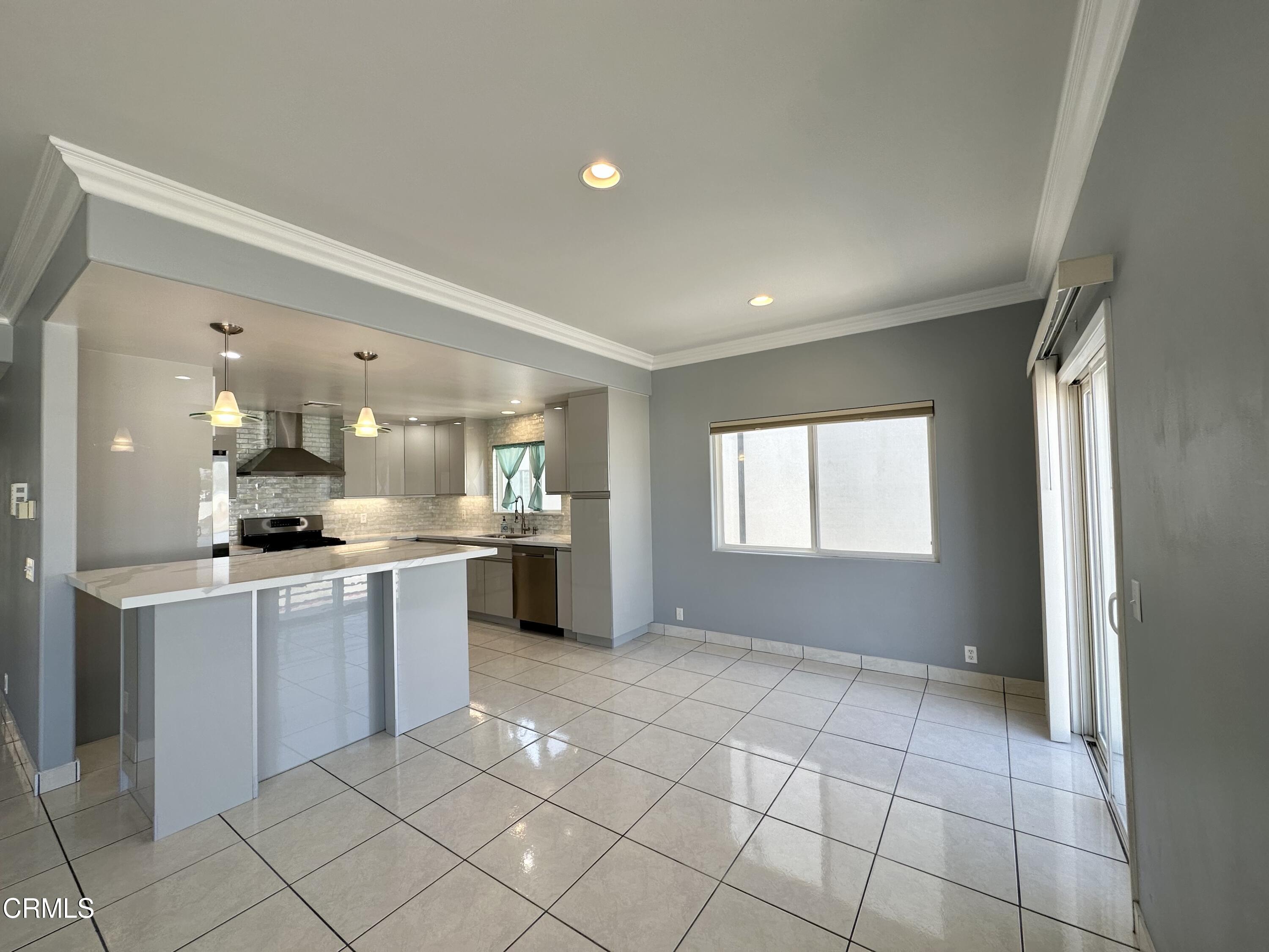 4053 Sunset Lane Oxnard, CA 93035 - Photo 11 of 34 a large kitchen with a sink and cabinets