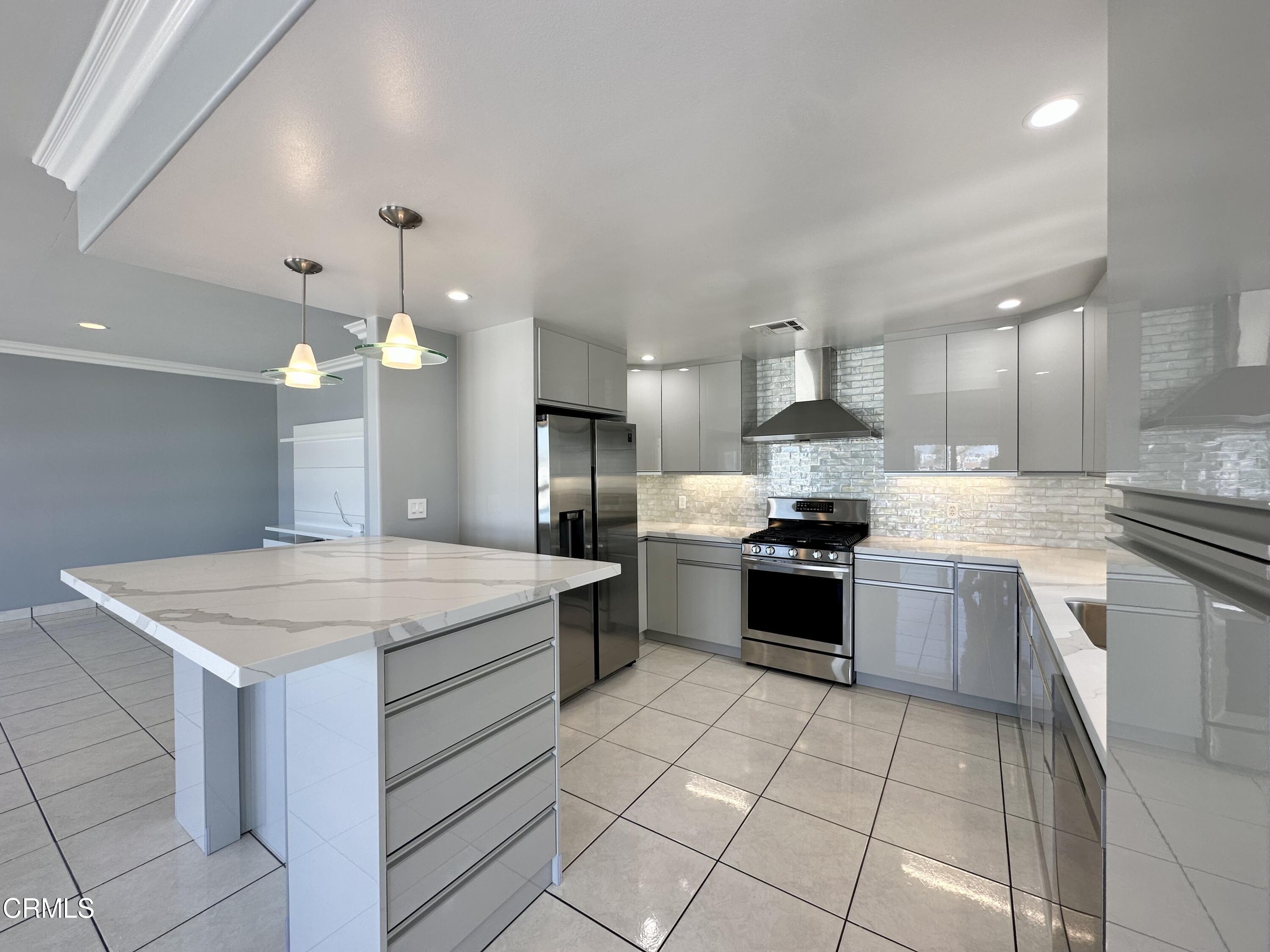 4053 Sunset Lane Oxnard, CA 93035 - Photo 12 of 34 a large kitchen with a stove a sink a microwave and a refrigerator