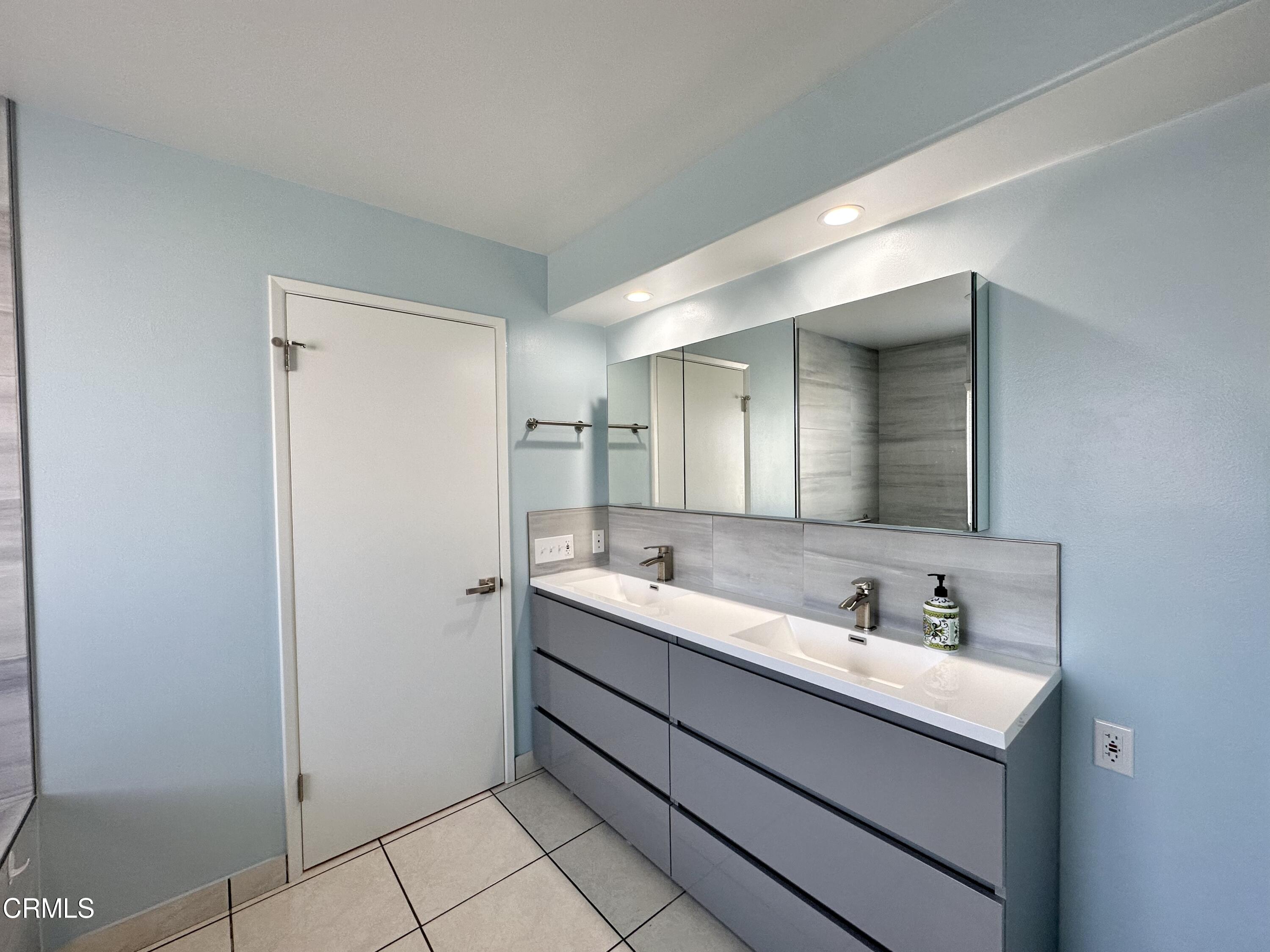 4053 Sunset Lane Oxnard, CA 93035 - Photo 20 of 34 a bathroom with a sink and a mirror