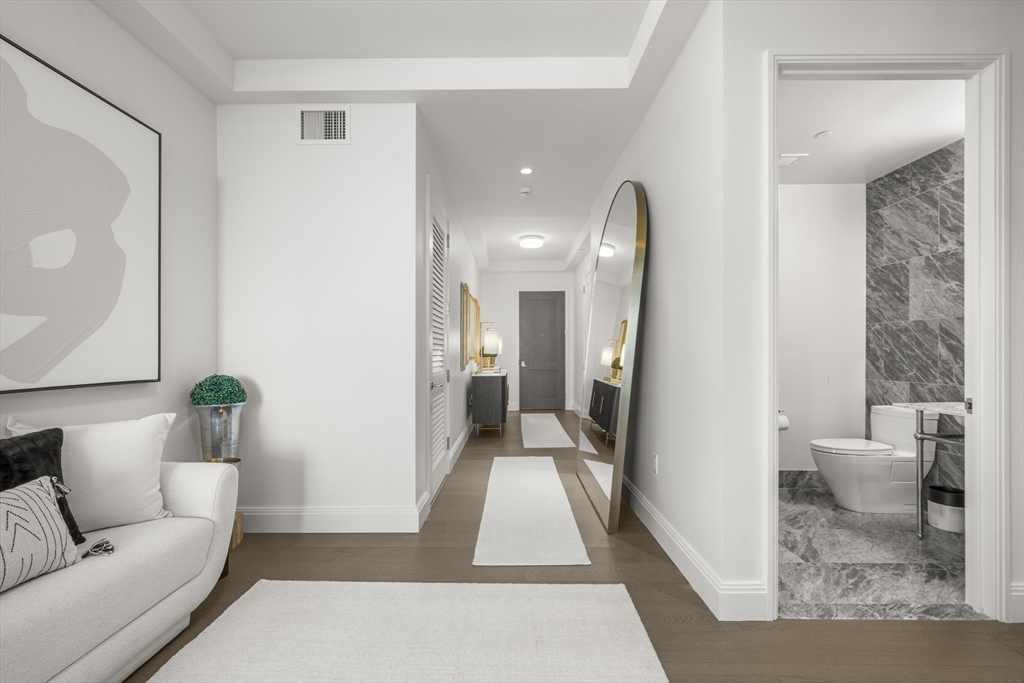 240 Devonshire Street, Unit 3701 Boston, MA 02110 - Photo 13 of 40 a living room with furniture and a rug