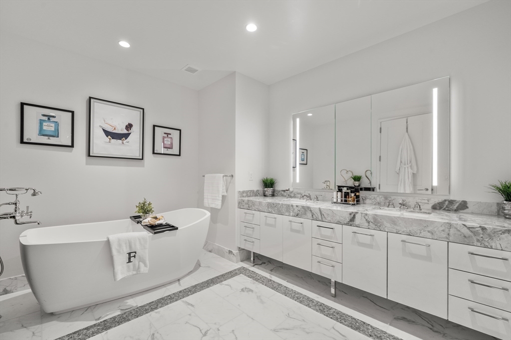 240 Devonshire Street, Unit 3701 Boston, MA 02110 - Photo 23 of 40 a spacious bathroom with a double vanity sink mirror and bathtub