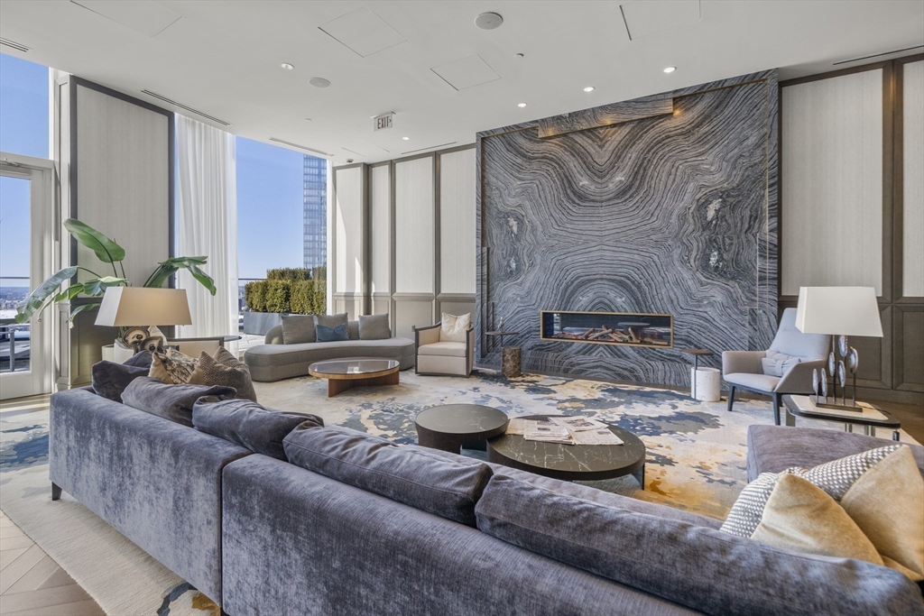 240 Devonshire Street, Unit 3701 Boston, MA 02110 - Photo 26 of 40 a living room with furniture and a fireplace