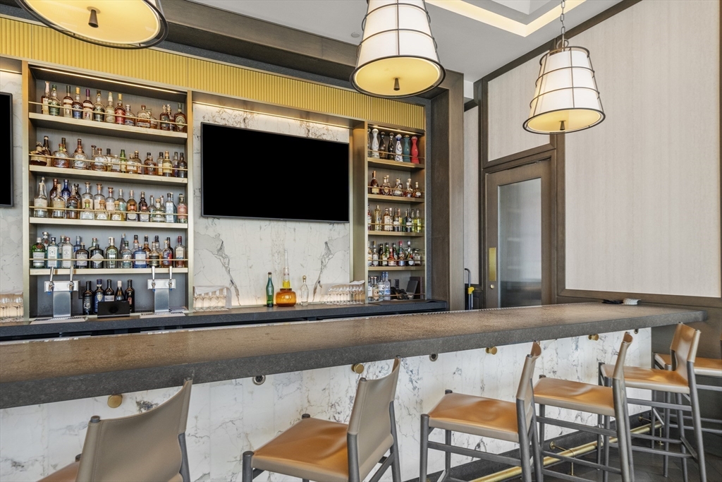 240 Devonshire Street, Unit 3701 Boston, MA 02110 - Photo 27 of 40 a living room filled with furniture and a flat screen tv