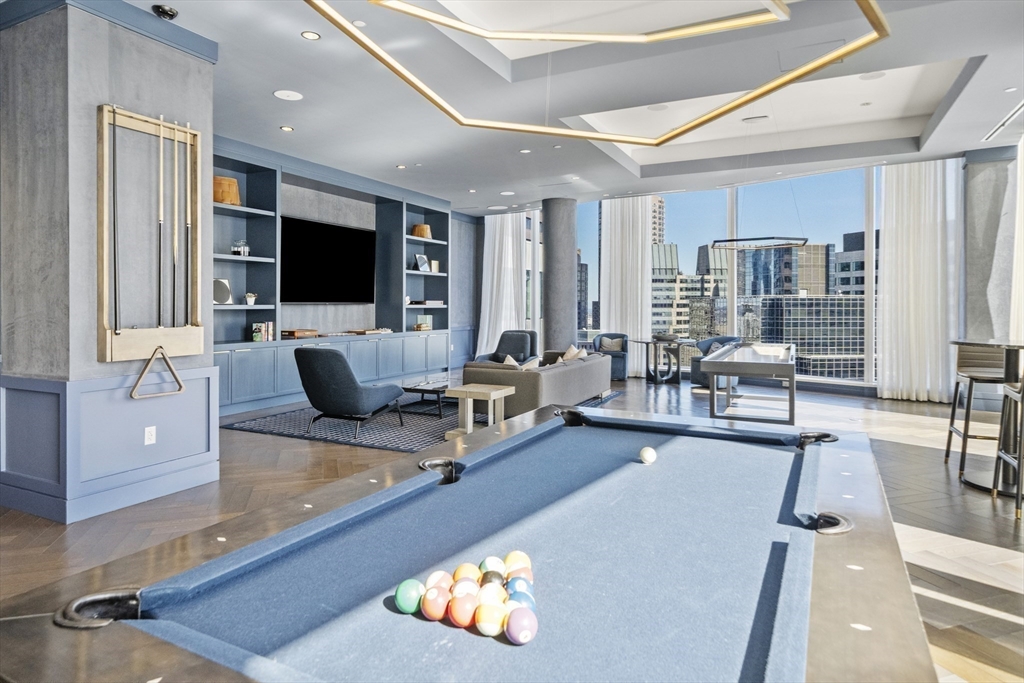 240 Devonshire Street, Unit 3701 Boston, MA 02110 - Photo 29 of 40 a living room with furniture and a flat screen tv