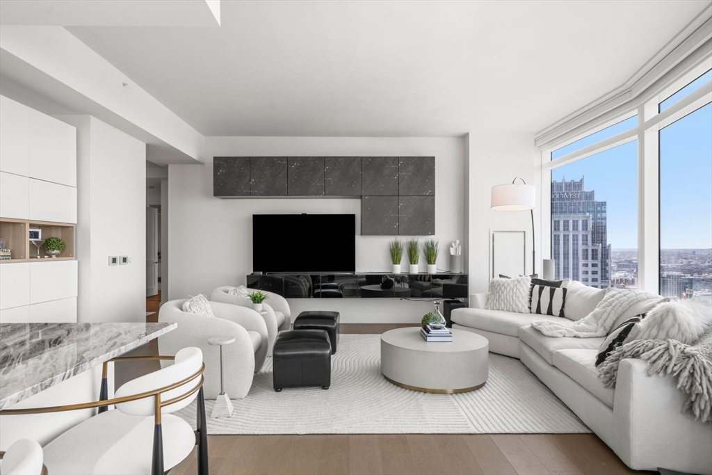 240 Devonshire Street, Unit 3701 Boston, MA 02110 - Photo 3 of 40 a living room with furniture and a flat screen tv