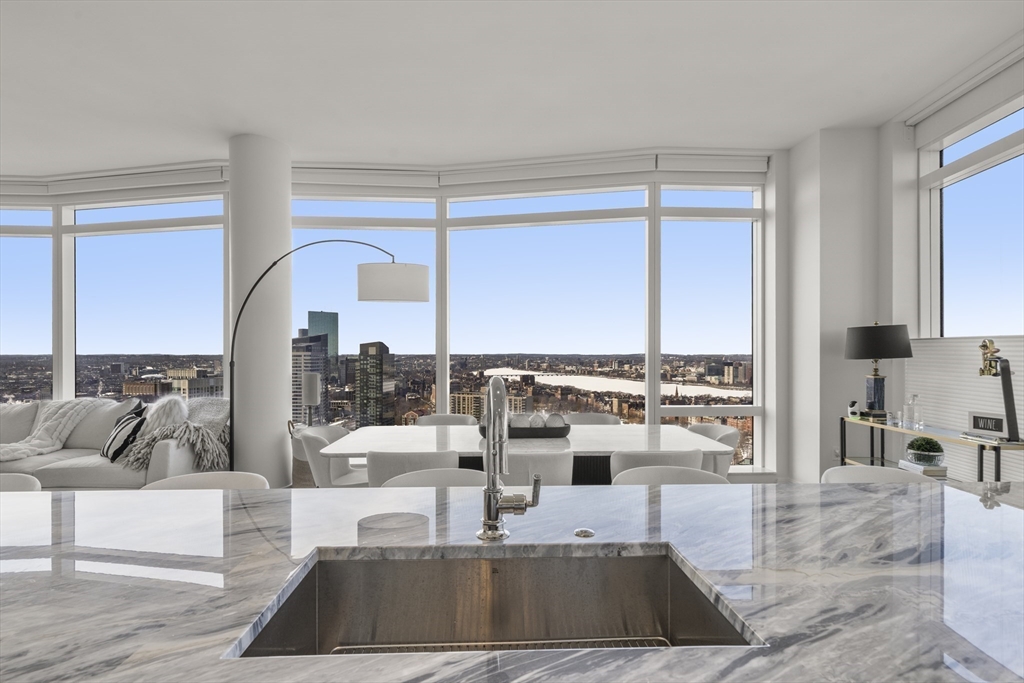 240 Devonshire Street, Unit 3701 Boston, MA 02110 - Photo 5 of 40 a view of a living room with a floor to ceiling window and kitchen view