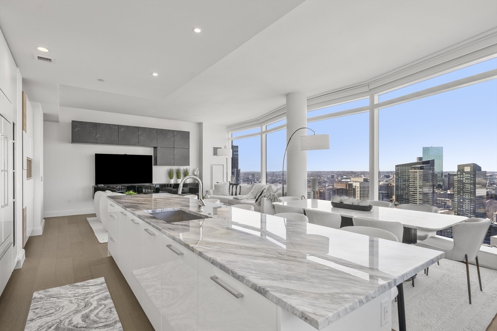 240 Devonshire Street, Unit 3701 Boston, MA 02110 - Photo 6 of 40 a living room with fireplace furniture and a flat screen tv