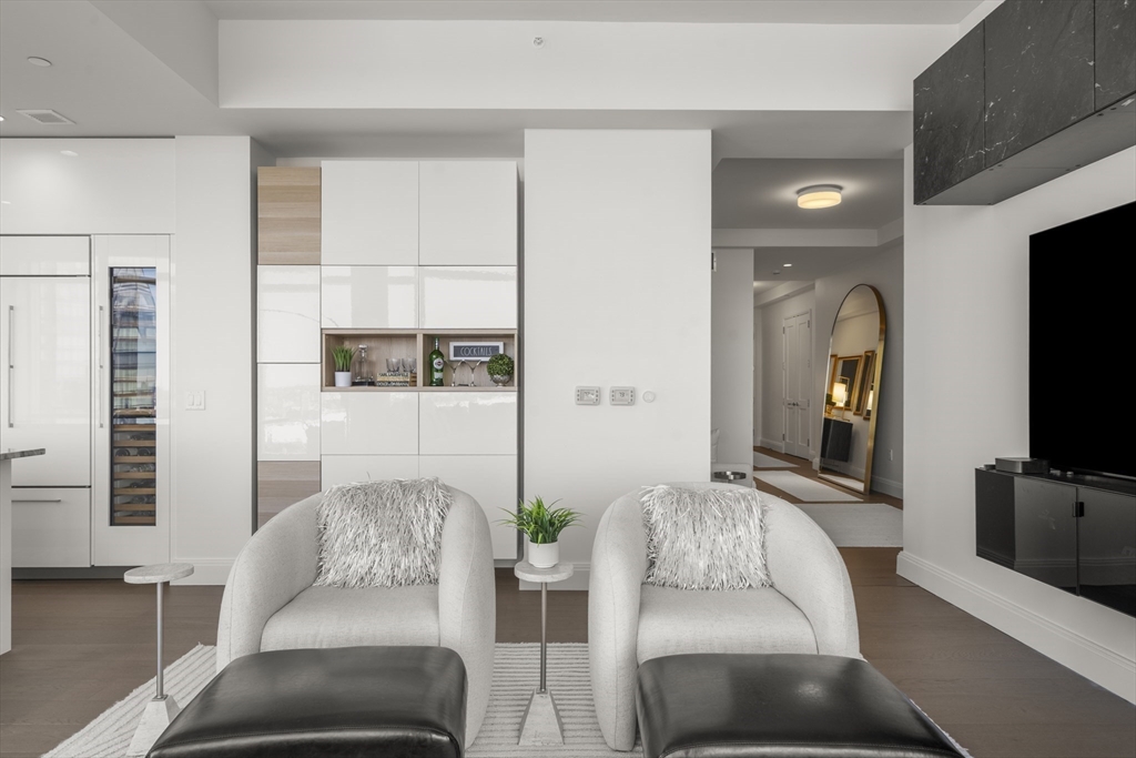 240 Devonshire Street, Unit 3701 Boston, MA 02110 - Photo 10 of 40 a living room with furniture and a flat screen tv