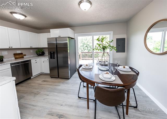 4750 Cheerful Road Colorado Springs, CO 80917 - Photo 13 of 48 Kitchen/dining combo with walk-out to the deck