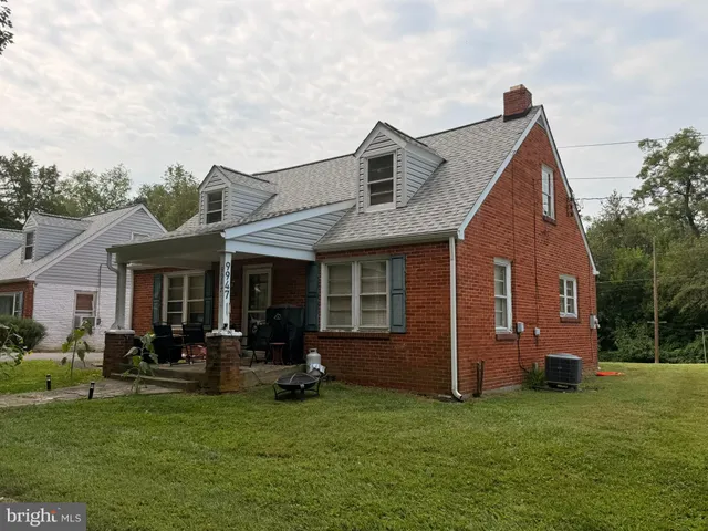 a view of a house with a yard porch and sitting area