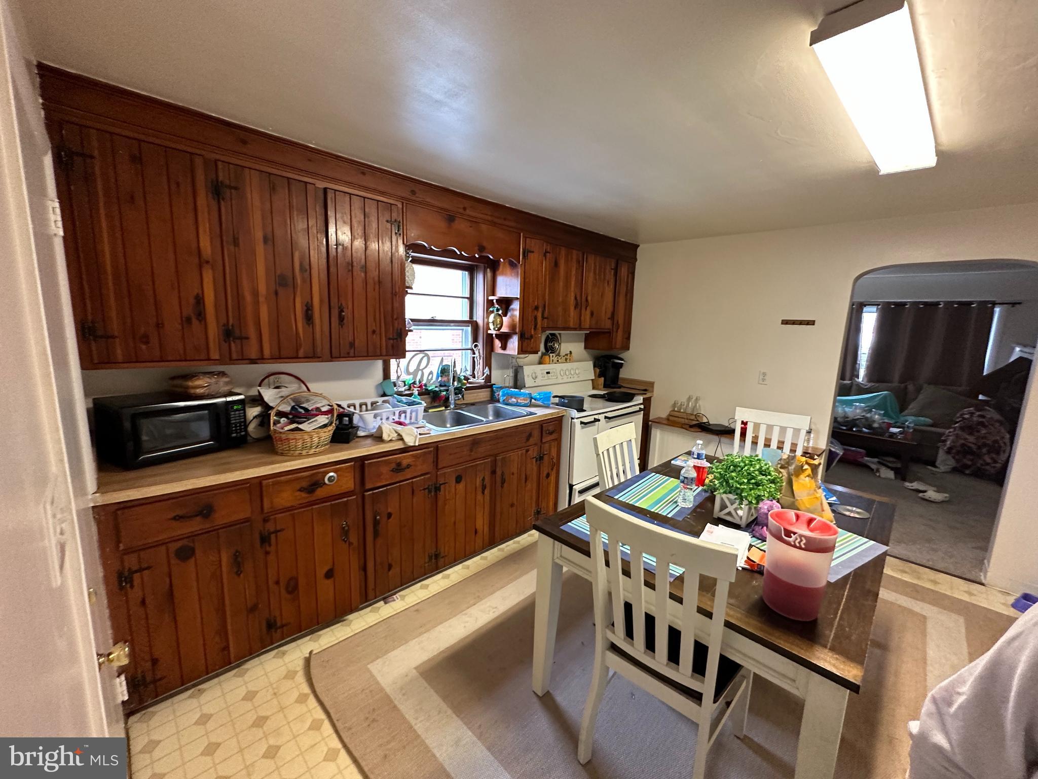 9947 Crossfield Road Hagerstown, MD 21740 - Photo 24 of 39 a kitchen with stainless steel appliances kitchen island granite countertop a table chairs in it and a window
